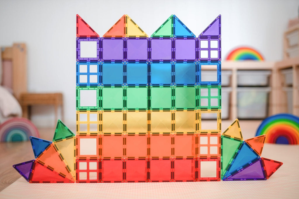 Colorful magnetic building blocks stacked on a table with a blurred indoor background
