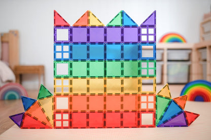 Colorful magnetic building blocks stacked on a table with a blurred indoor background
