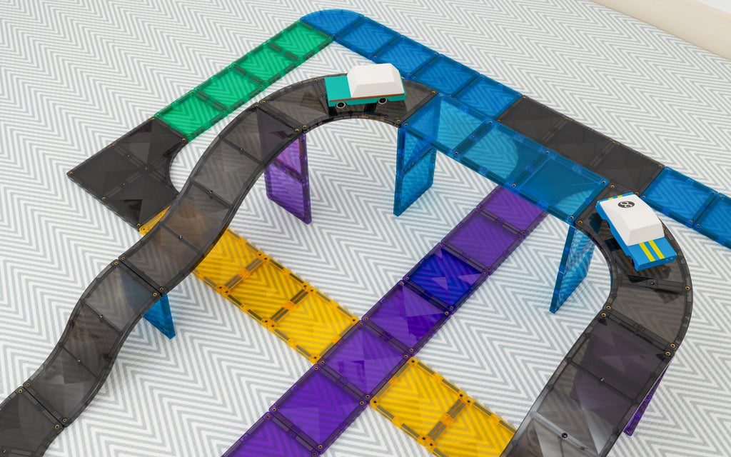 Colorful toy train track set on a patterned surface