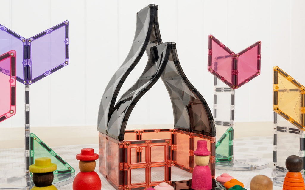 Colorful geometric toy structure with transparent panels on a white background