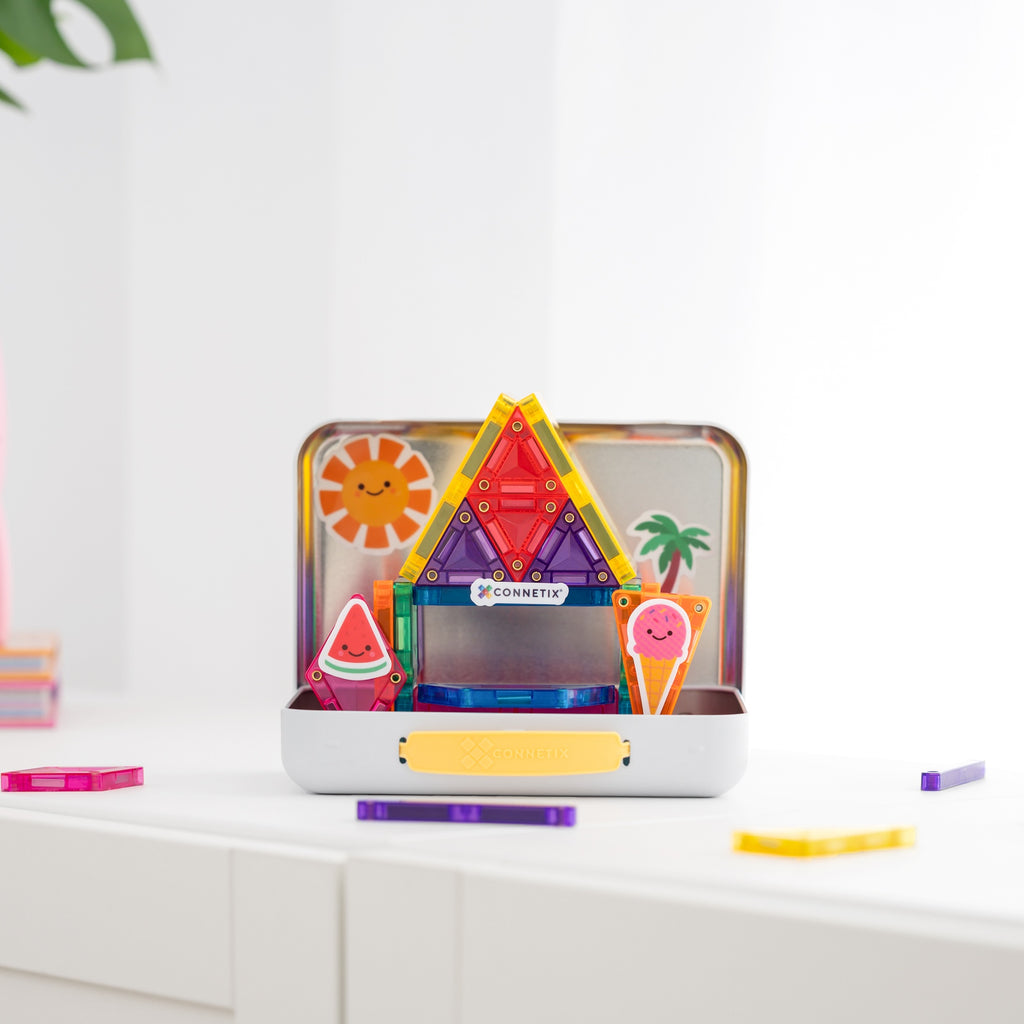 A colorful magnetic building toy set in a white storage case, displayed on a white surface with a clean white background. The set includes various geometric and themed magnetic pieces like a sun, watermelon, ice cream cone, and palm tree, with the brand name 'KONNETICO' visible on a small tag.