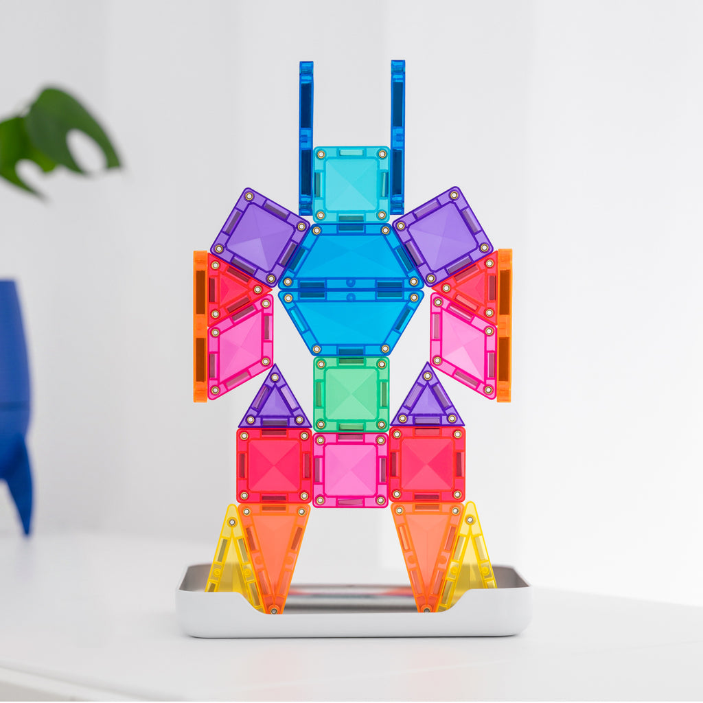 A colorful magnetic building toy assembled into a humanoid robot figure, standing on a silver base against a clean white background.