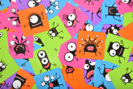 Colorful fabric with cartoon monster designs on a multicolored background