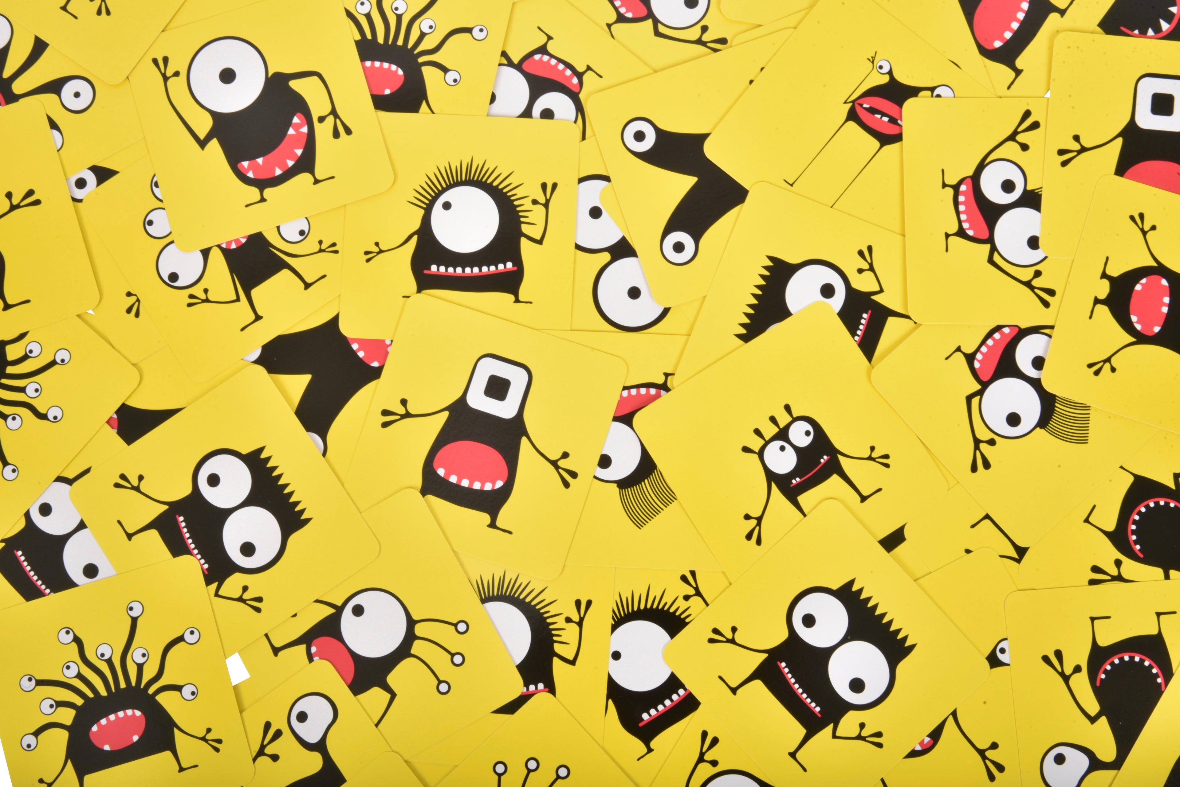 Pattern of cartoonish monsters on a yellow background