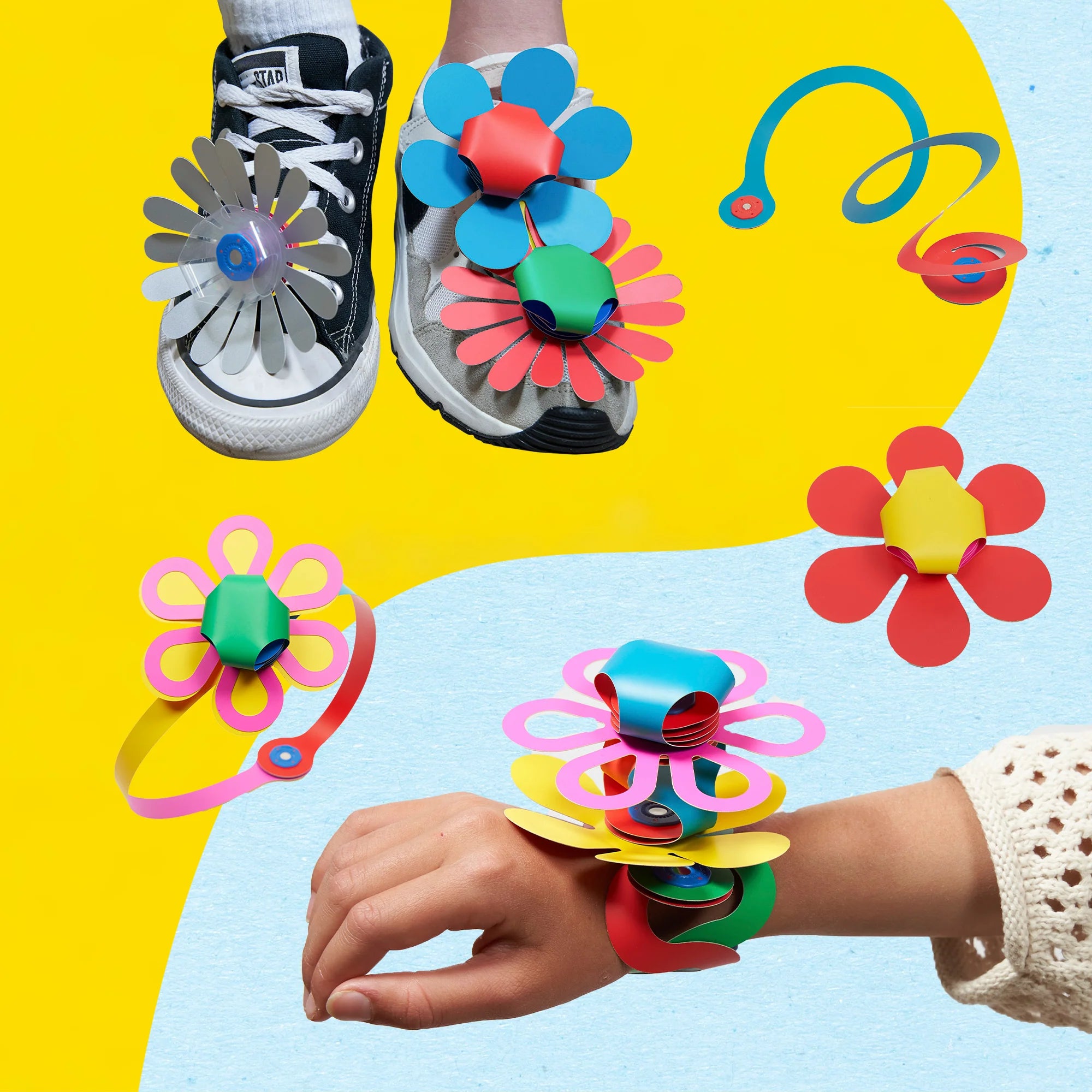 Colorful flower-shaped accessories on shoes and a wrist against a yellow and blue background