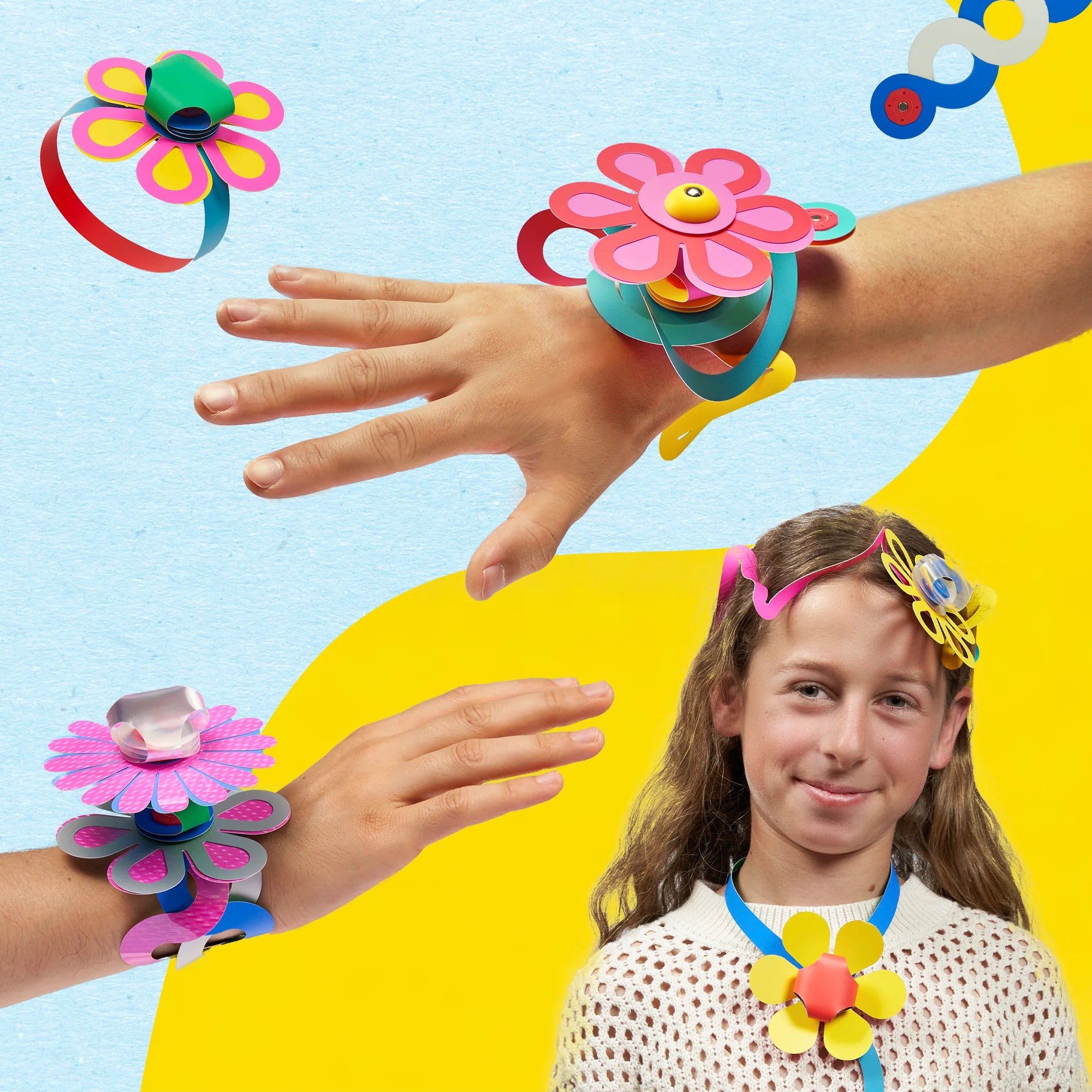 Children wearing colorful flower-shaped headbands and bracelets against a bright background