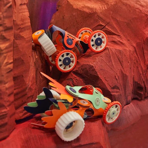 Toy car with orange wheels on a red textured surface