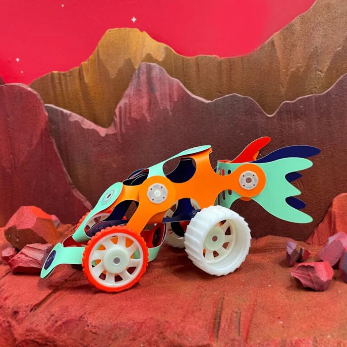 Toy vehicle on a red and brown mountainous background