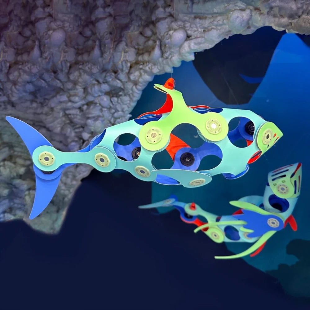 Colorful fish-shaped toy with gears in an underwater setting