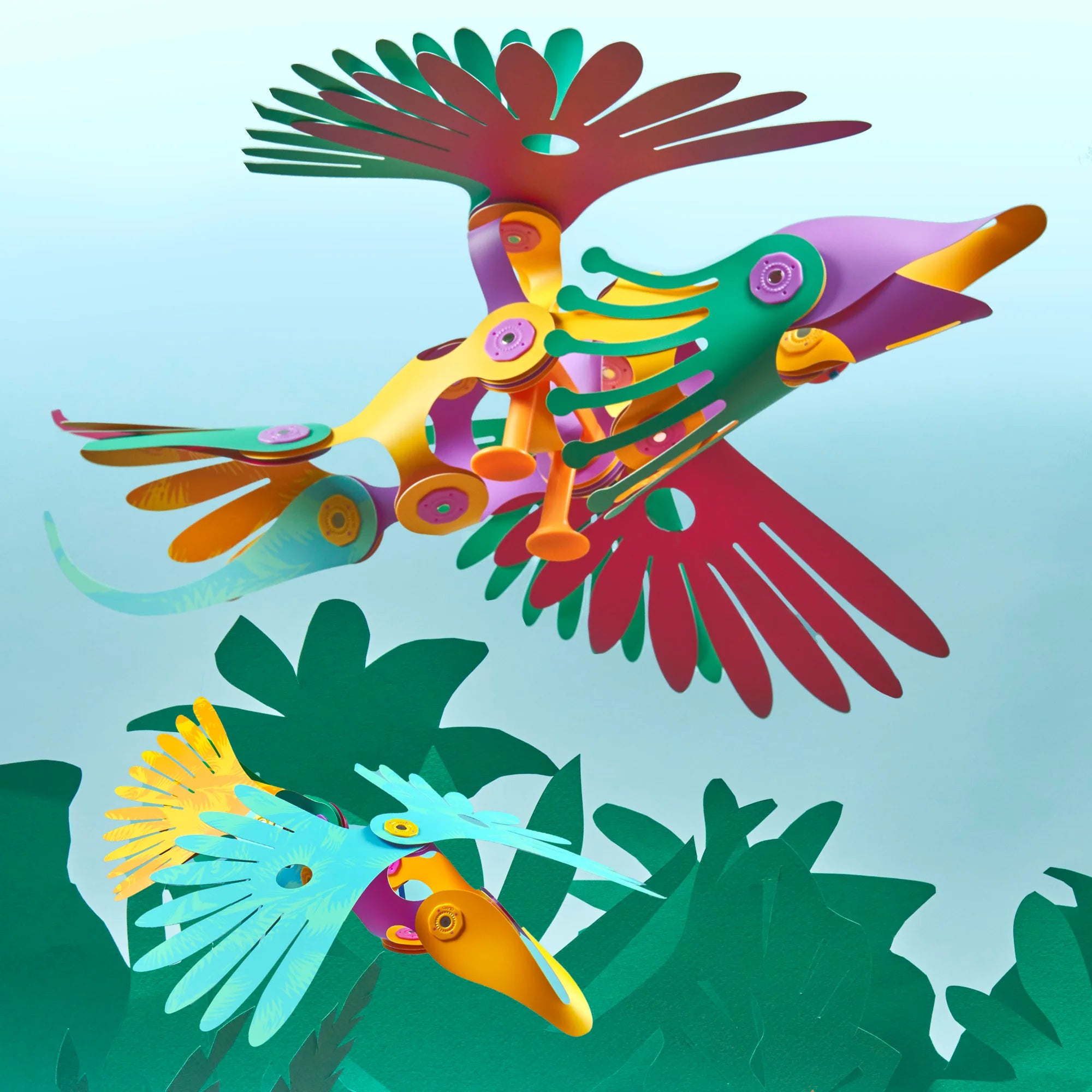 Colorful bird-shaped sculptures on a light blue background with green leaves.