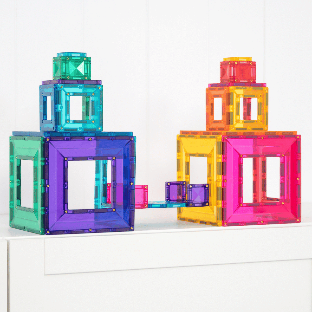 Colorful transparent magnetic building blocks on a white surface