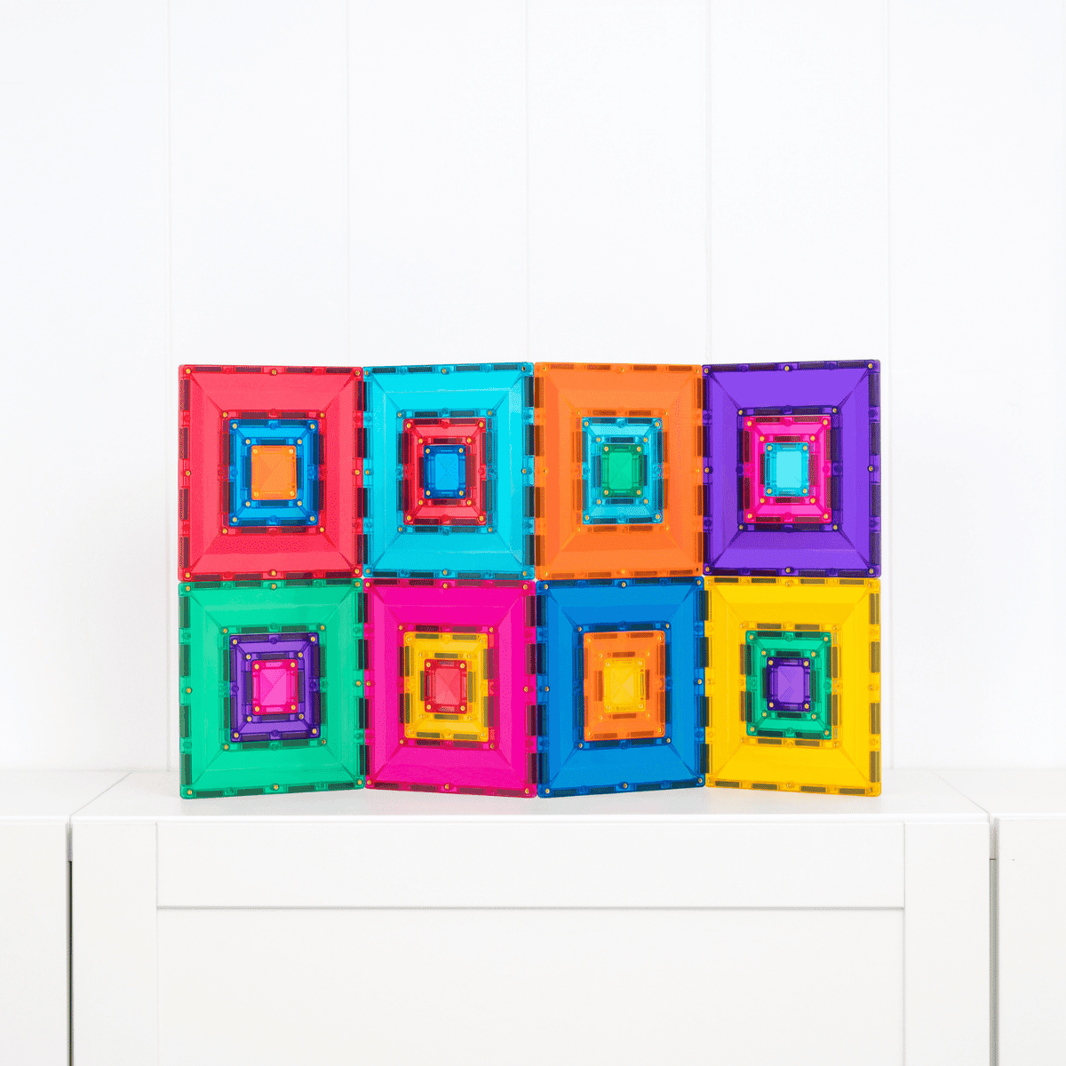 Colorful magnetic building blocks on a white surface