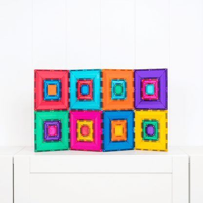 Colorful magnetic building blocks on a white surface