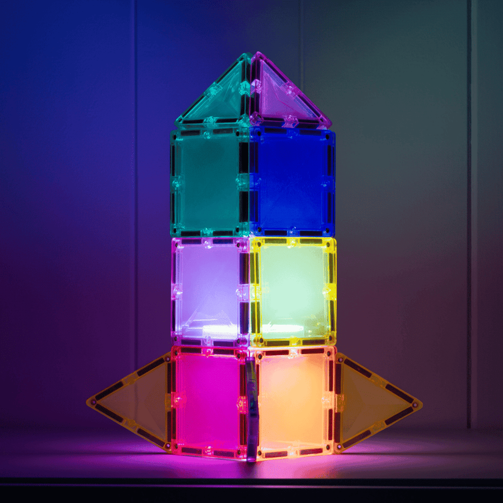 Colorful magnetic building block tower against a dark background