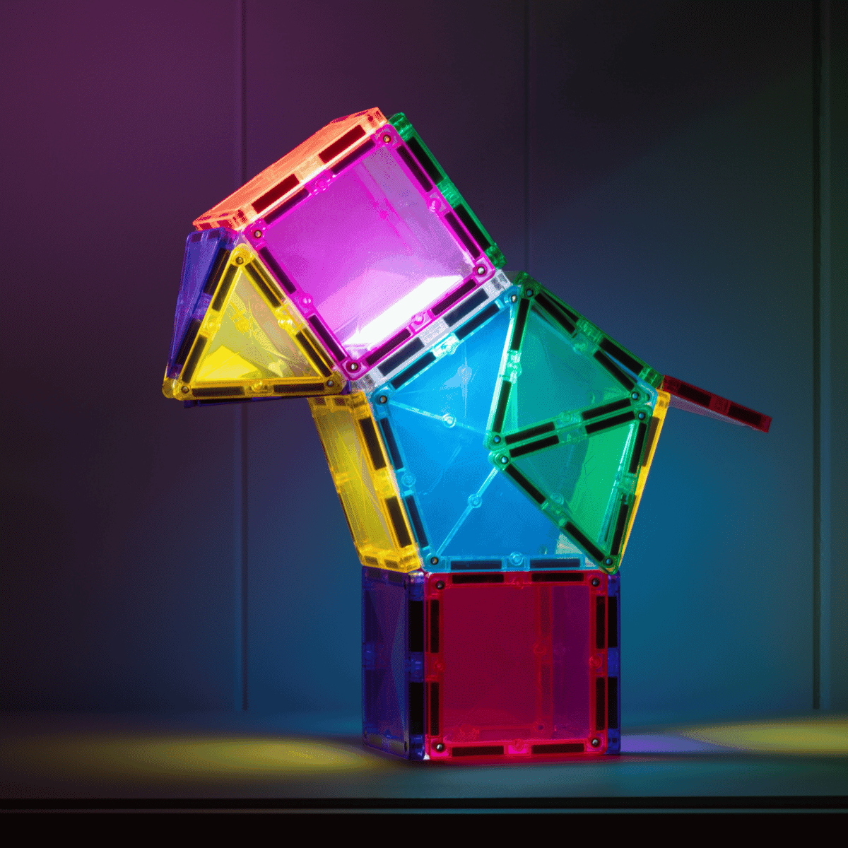 Colorful magnetic building blocks stacked against a dark background