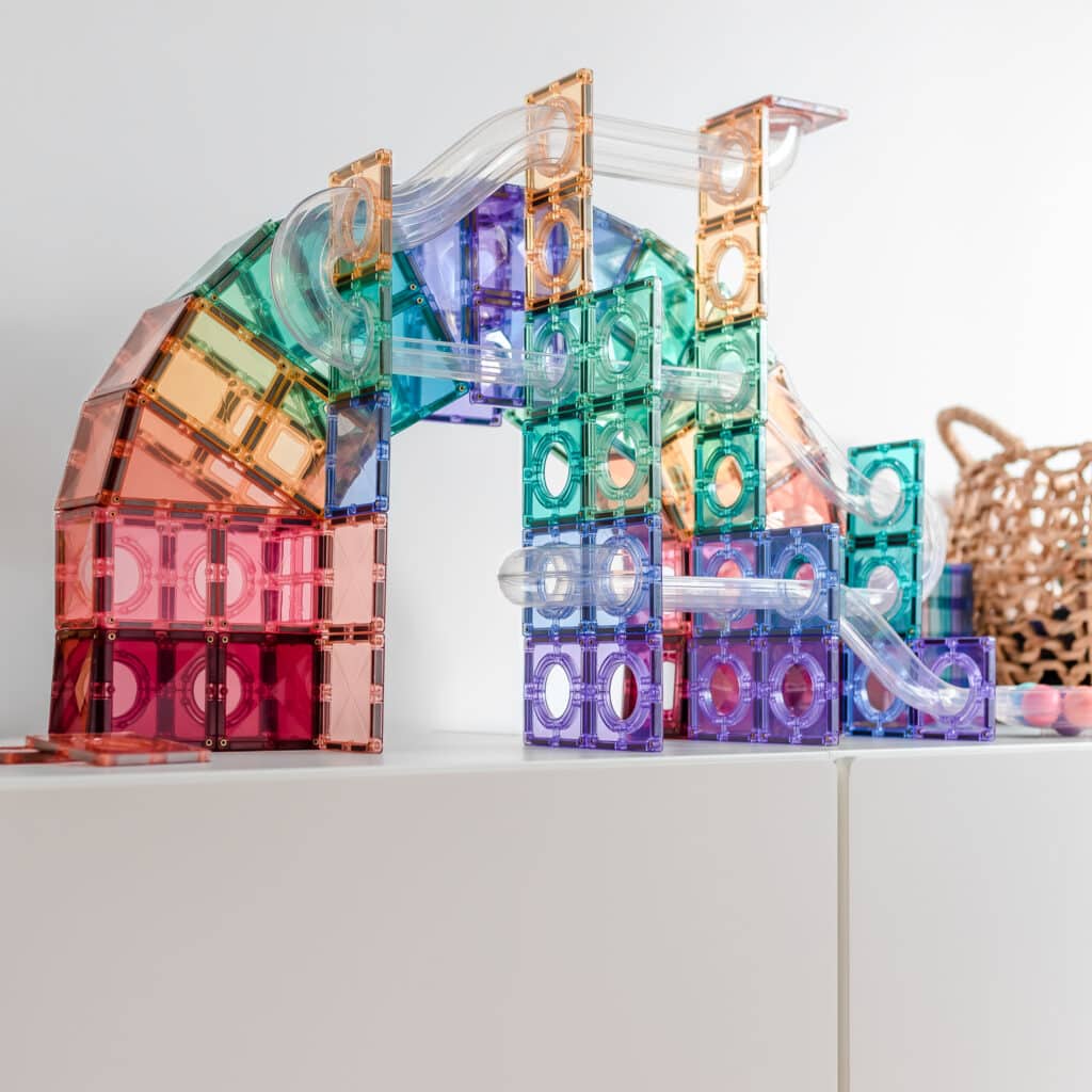 Colorful transparent building blocks on a white surface with a neutral background