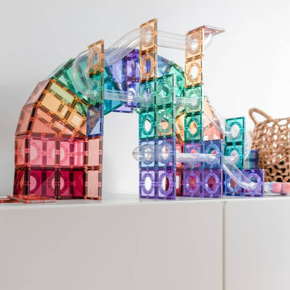Colorful transparent building blocks on a white surface with a neutral background