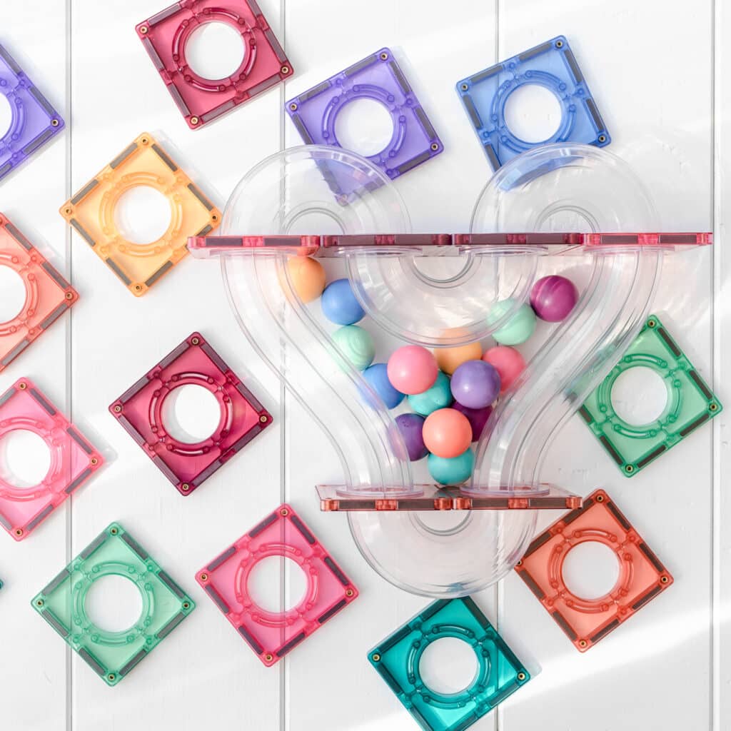 Colorful plastic toys with transparent tubes and colorful balls on a white background