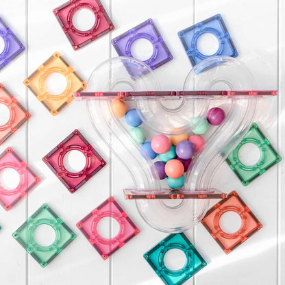 Colorful plastic toys with transparent tubes and colorful balls on a white background