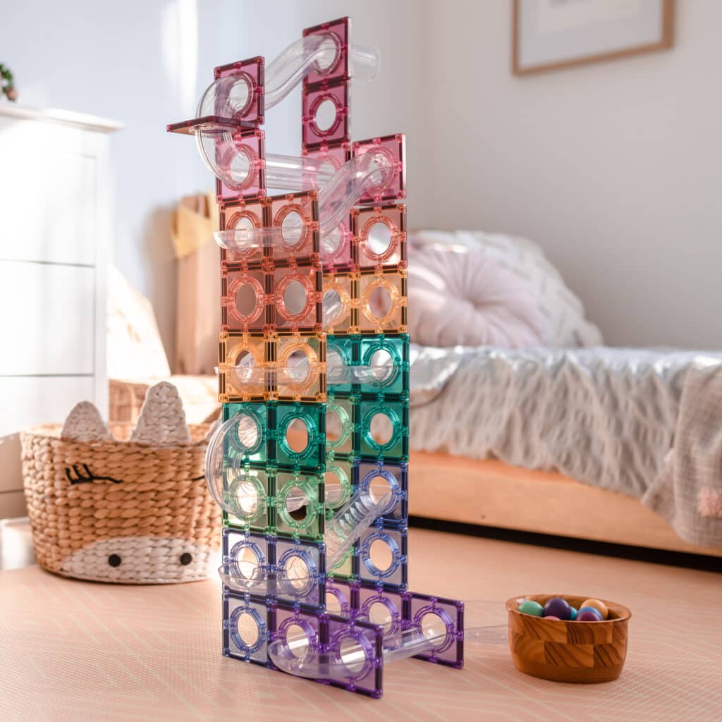 Colorful transparent tower structure on a wooden surface with a blurred indoor background