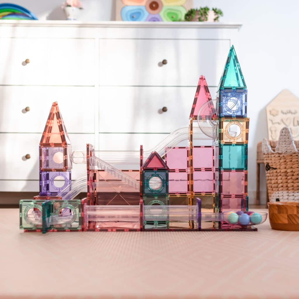 Colorful magnetic building blocks on a table with a white cabinet in the background