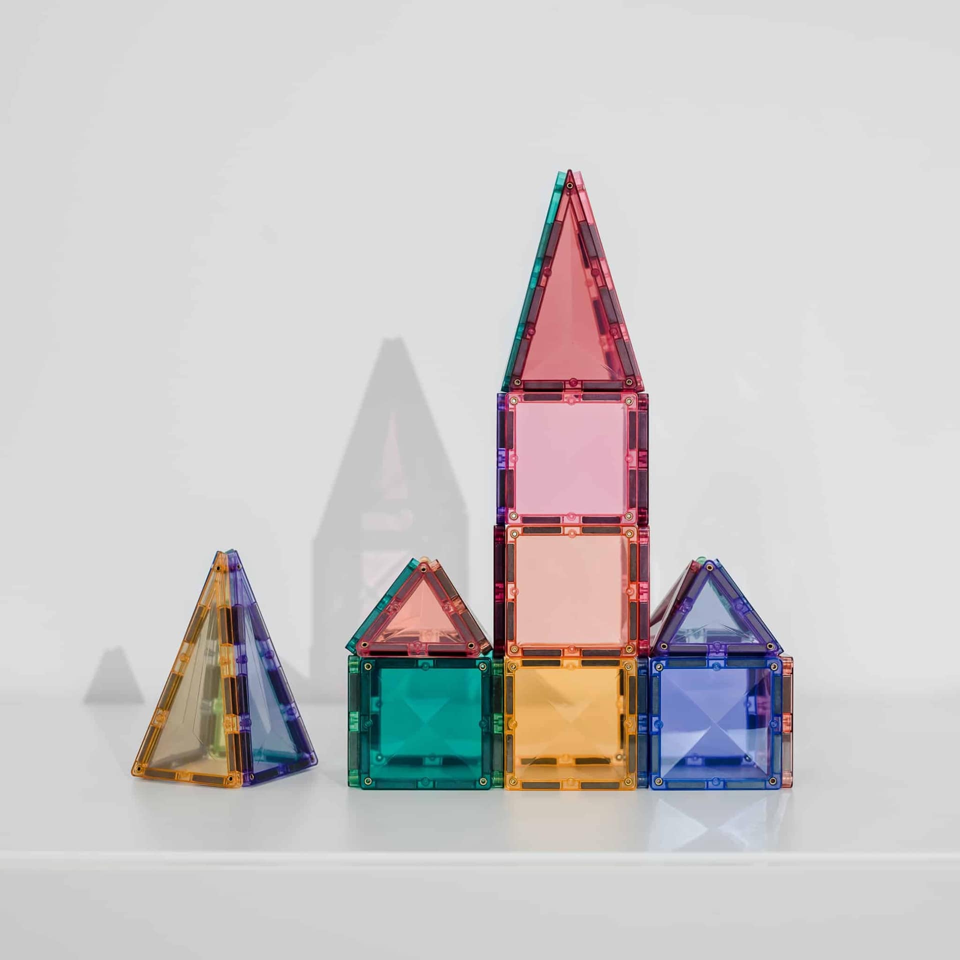 Colorful geometric transparent blocks on a light gray background