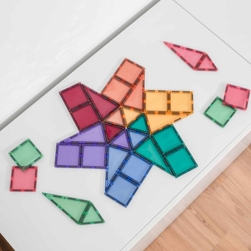 Colorful geometric transparent building blocks on a white surface