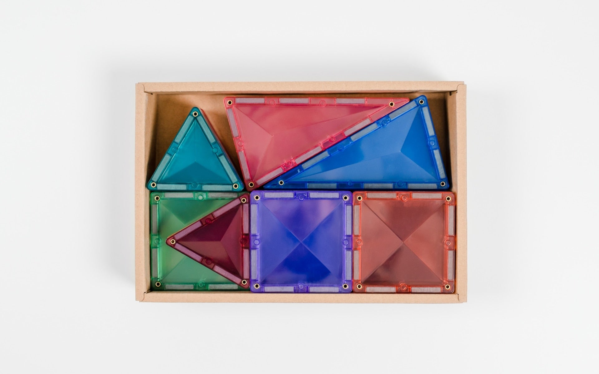 Colorful transparent geometric shapes in a wooden box on a white background