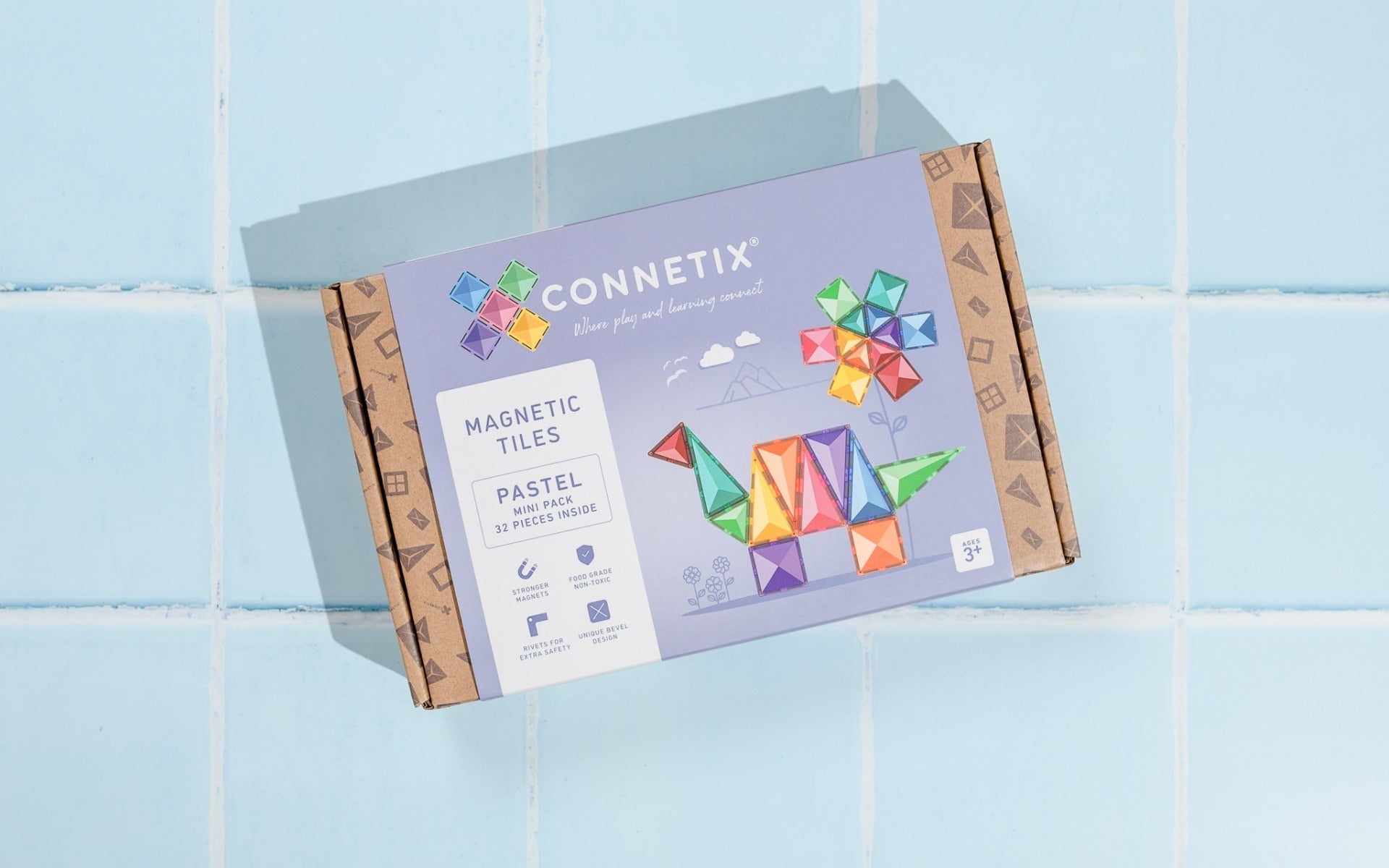 Connetix magnetic tiles packaging on a light blue tiled background
