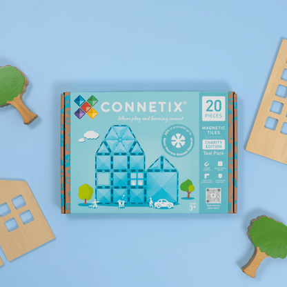 CONNETIX magnetic tiles packaging on a blue background with toy buildings and trees around