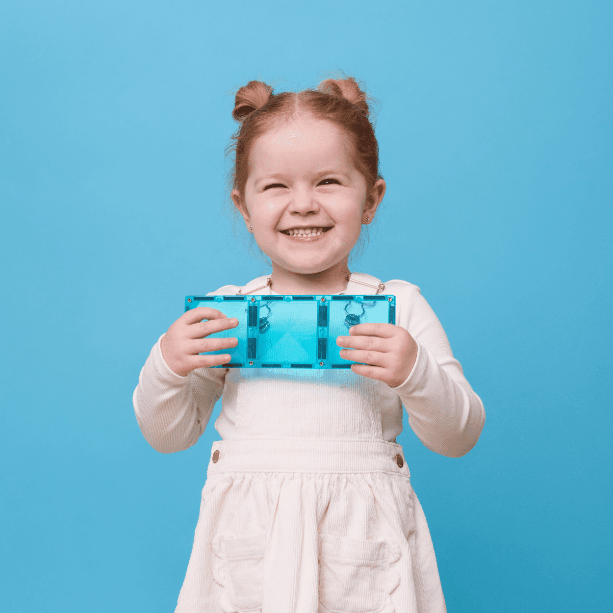 Child holding a blue transparent object against a blue background
