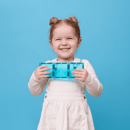 Child holding a blue transparent object against a blue background