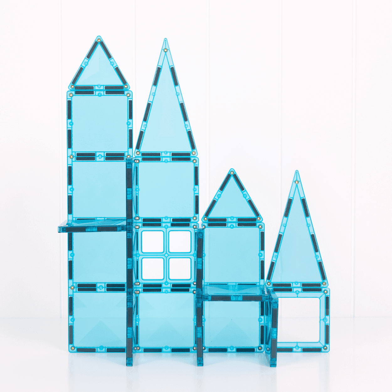 Blue transparent magnetic building blocks stacked on a white background