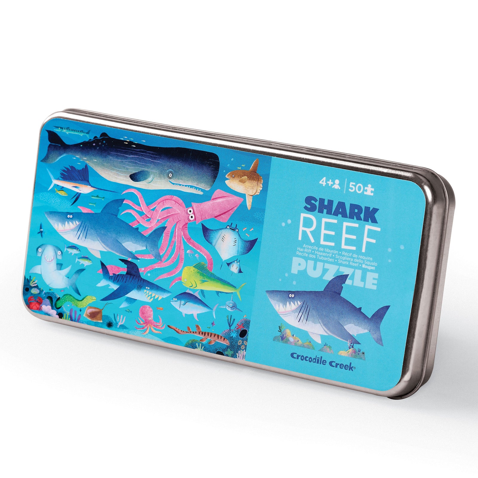 A 50-piece puzzle depicting various shark and reef creatures, packaged in a tin box with a matching design.