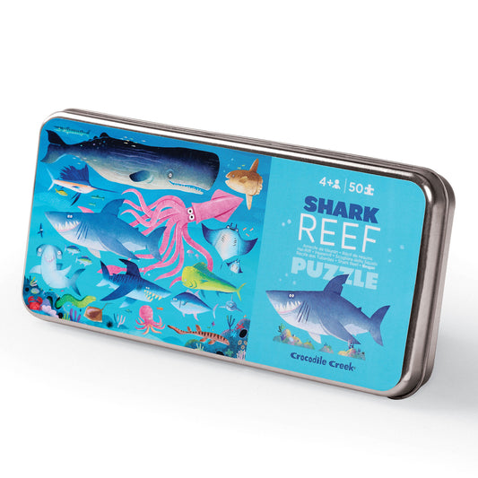 A 50-piece puzzle depicting various shark and reef creatures, packaged in a tin box with a matching design.