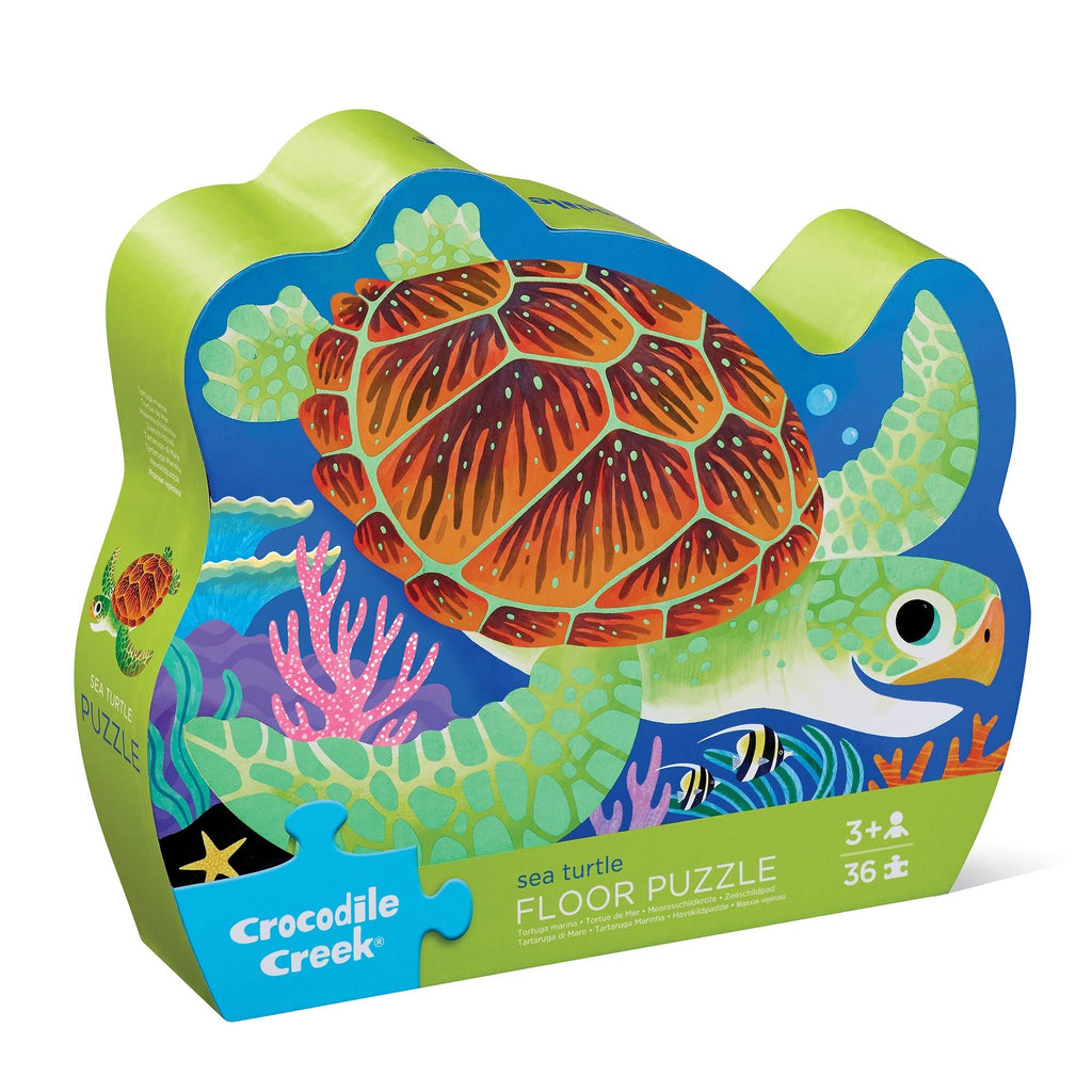 A 36-piece floor puzzle with a sea turtle design, packaged in a contour-shaped box with the product visible through a clear window.