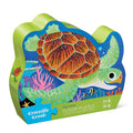 A 36-piece floor puzzle with a sea turtle design, packaged in a contour-shaped box with the product visible through a clear window.