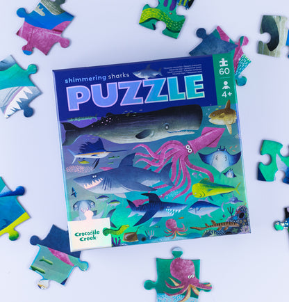 Shimmering Sharks puzzle with pieces scattered on a white background