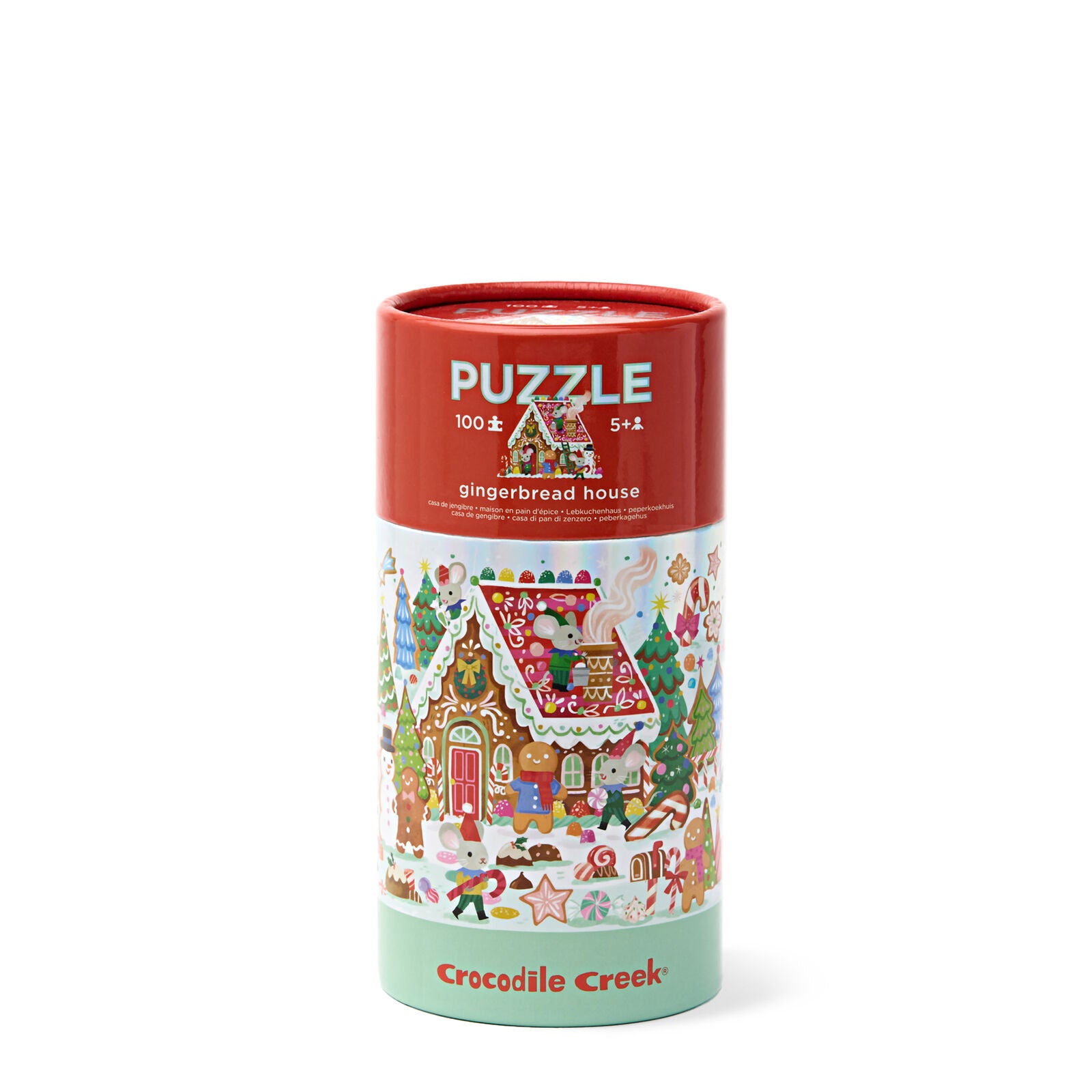 Crocodile Creek 100-piece gingerbread house puzzle in a cylindrical cardboard box with a red top, white middle section showing the illustrated puzzle design, and a mint green bottom band.
