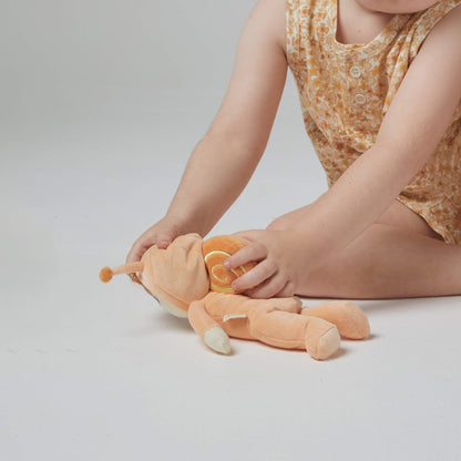 Child playing with a plush toy on a plain background