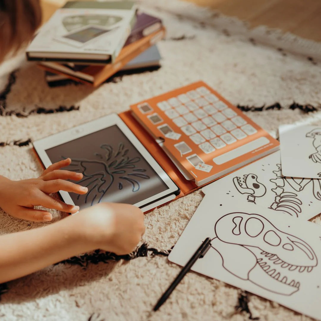Person interacting with a coloring book on a textured surface