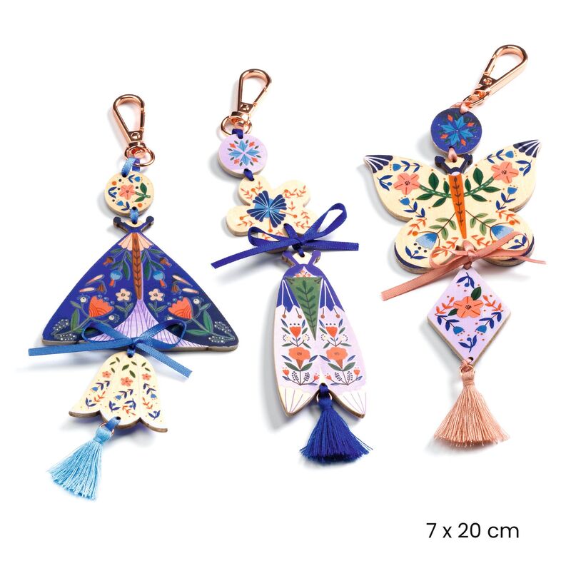 Set of colorful keychains with floral designs on a white background