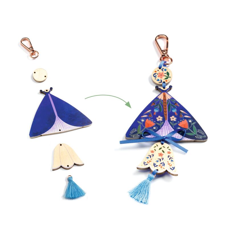 Decorative keychains with floral designs and tassels on a white background