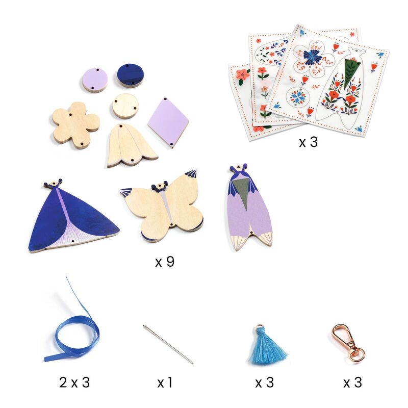 Collection of wooden butterfly toys, decorative cards, ribbons, and other small items on a white background
