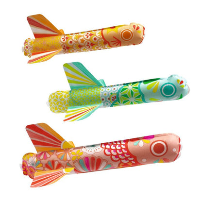 Three colorful toy planes with floral and abstract patterns on a white background