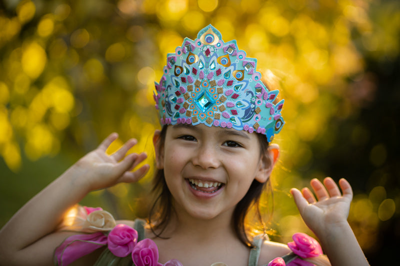 Child wearing a colorful princess tiara with a blurred natural background