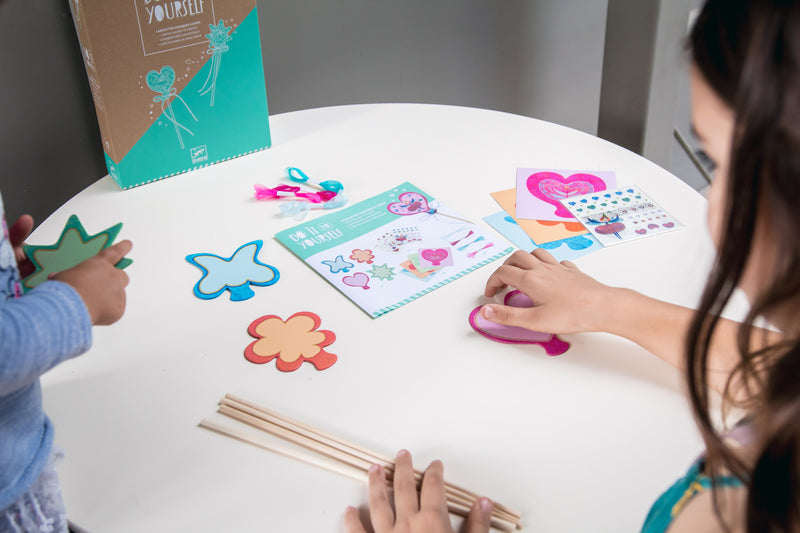 Child with contents of kit on a table.