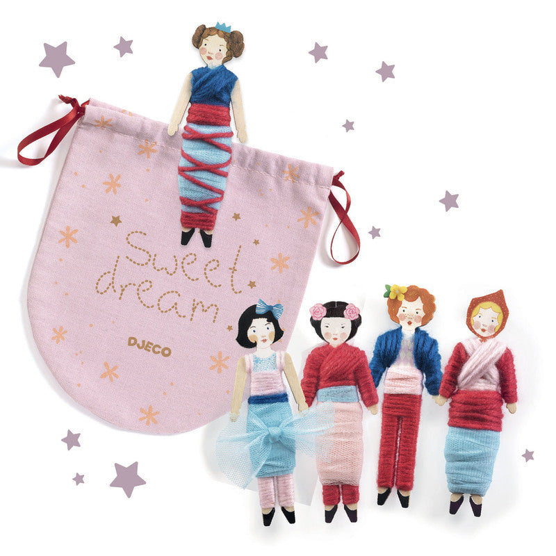 Bag with sweet dreams written on it and five wooden dolls on a white background.