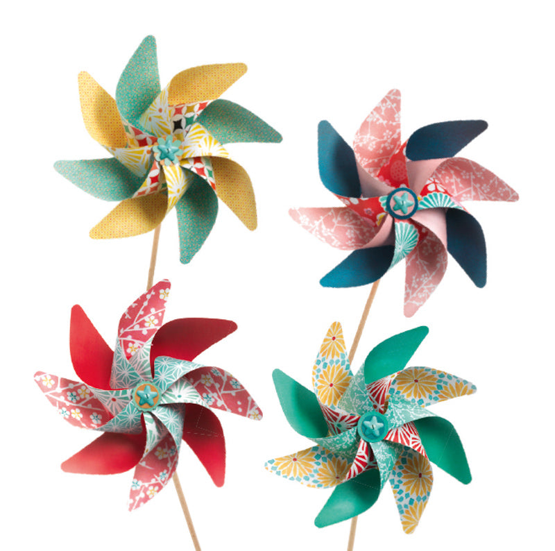 Four colourful paper windmills on a white background.