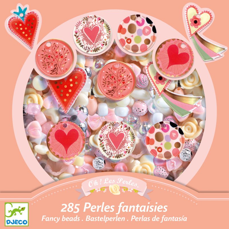 Box of colorful fantasy beads with heart designs on a pink background, featuring the Djeco brand.